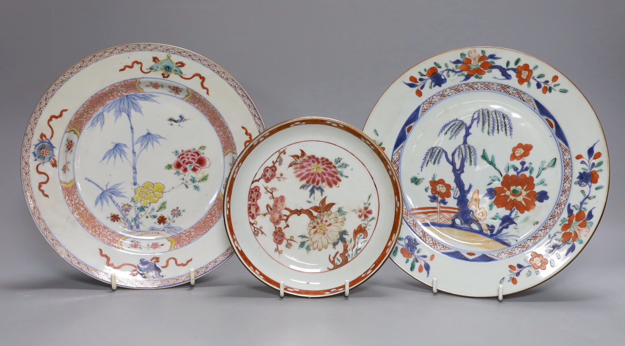 An 18th century Chinese export famille rose plate, similar saucer and an 18th century Chinese vert Imari plate, largest 22.5cm